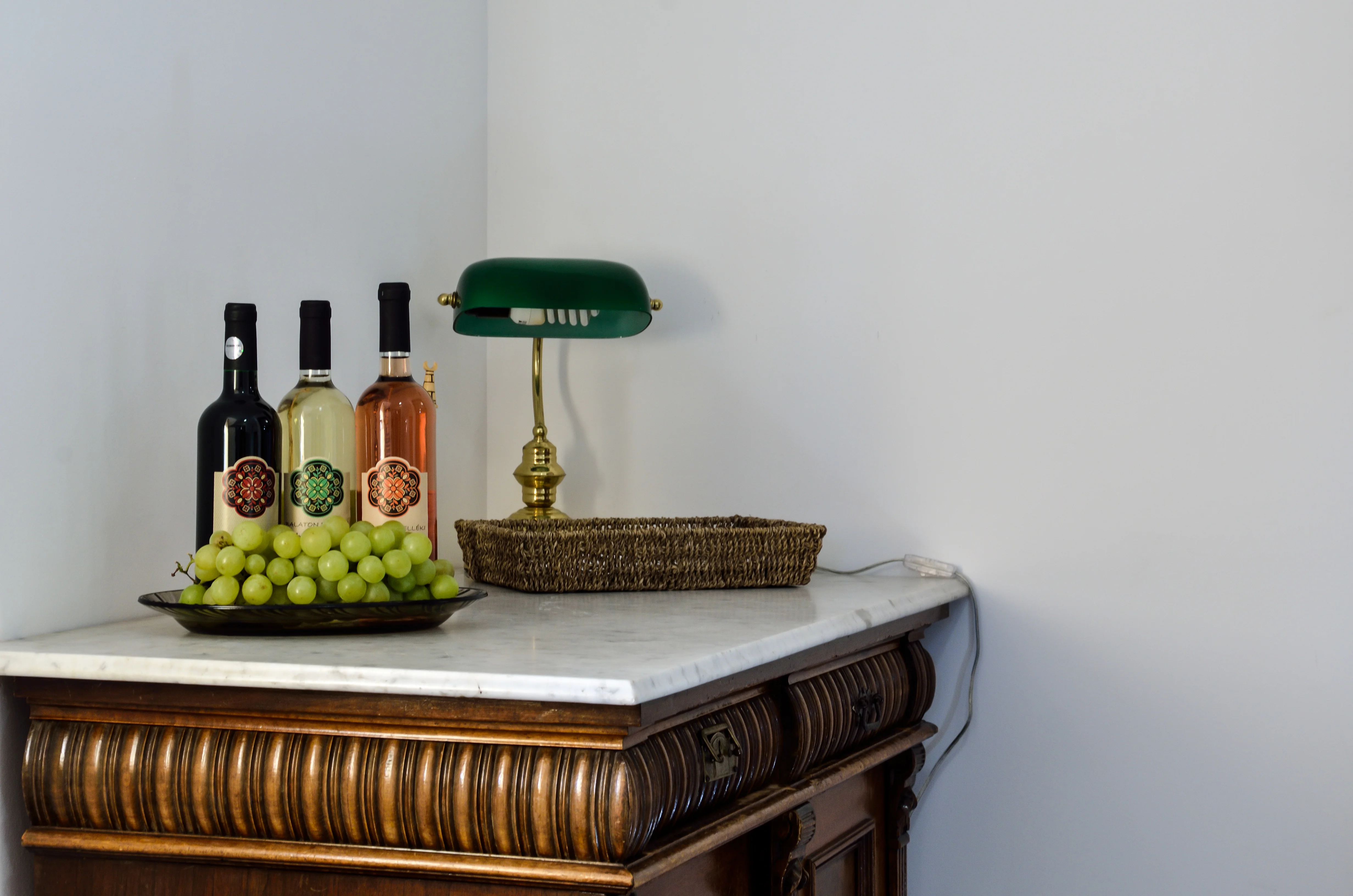 Antique sideboard with wines and banker's lamp